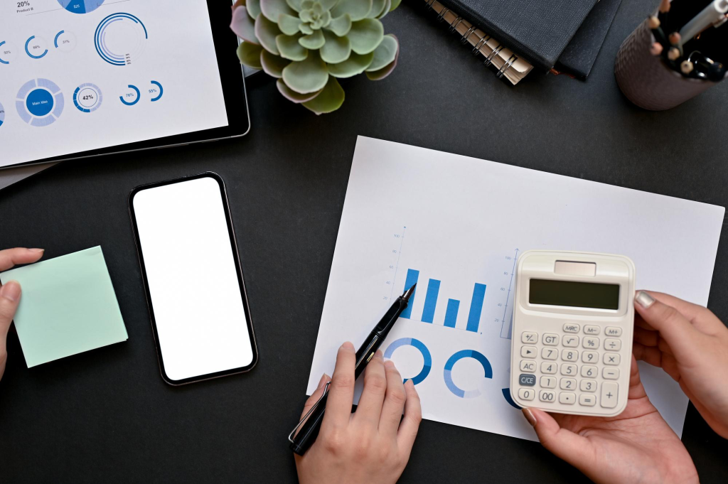 white calculator and blue graphs